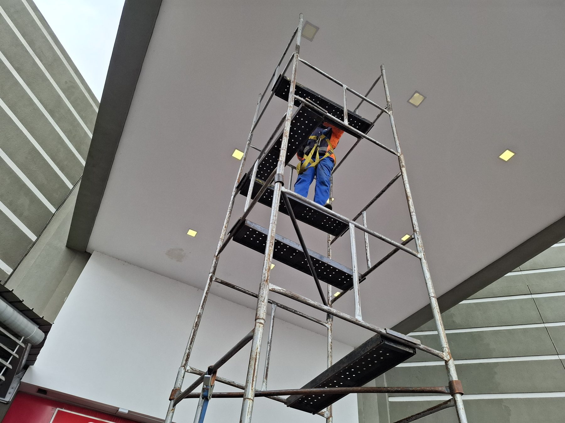 Full scaffolding tower erected under canopy