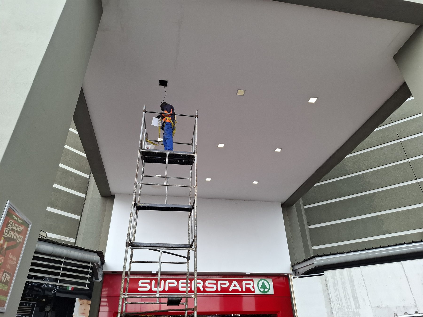 Scaffolding against the full canopy facade