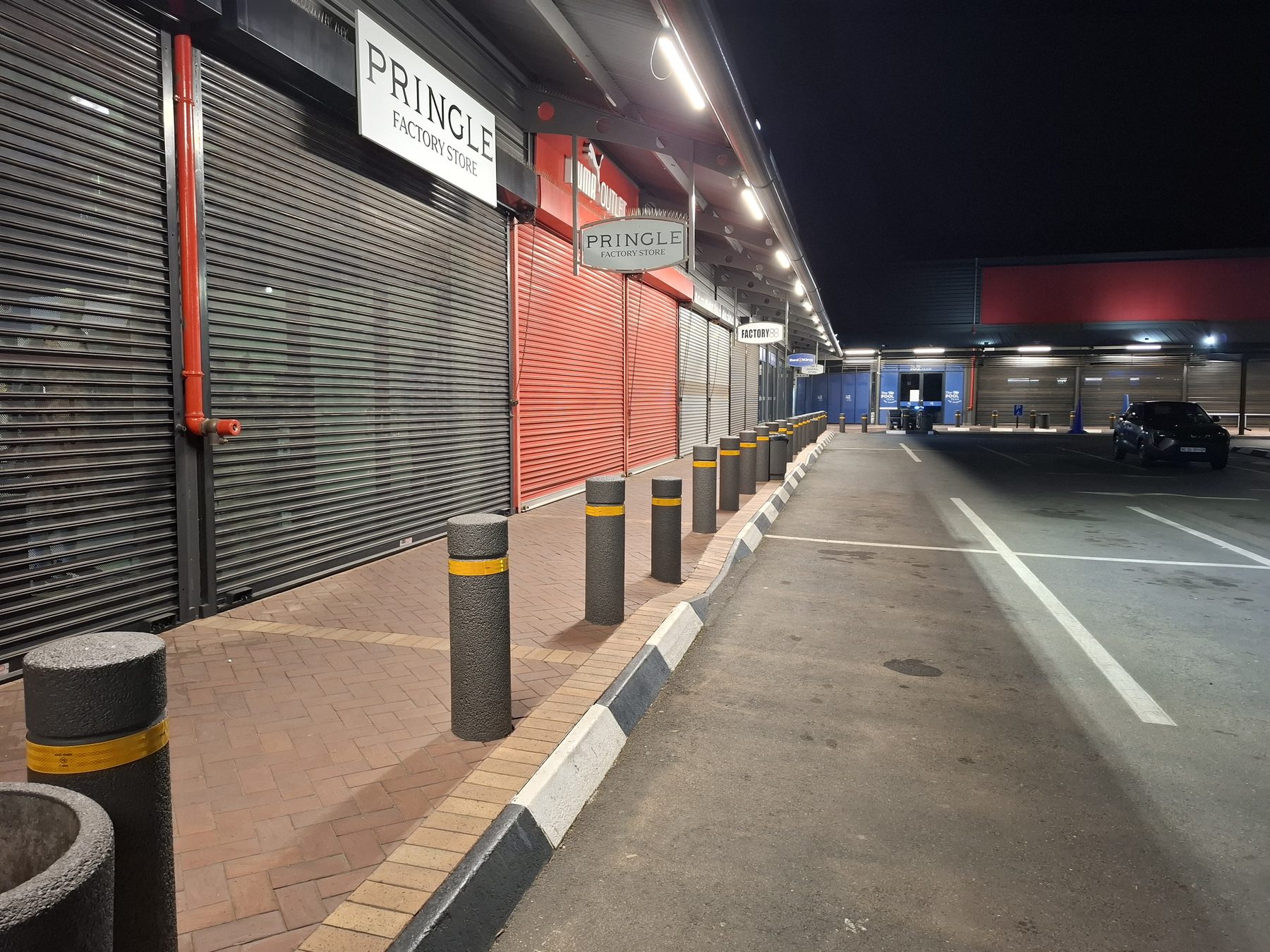 Storefront walkway lit by new canopy lighting