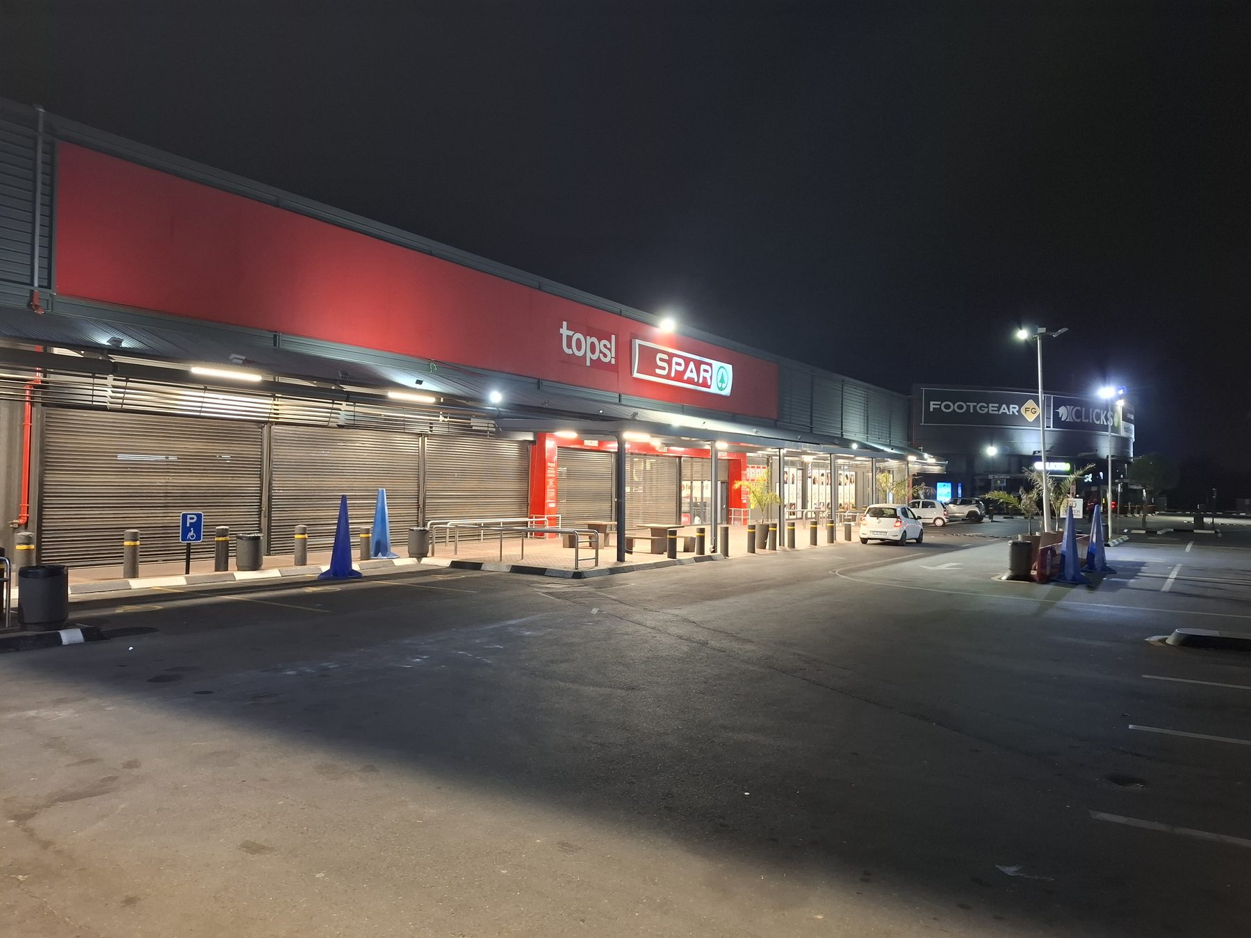 Fully illuminated shopping centre facade at night after the lighting upgrade