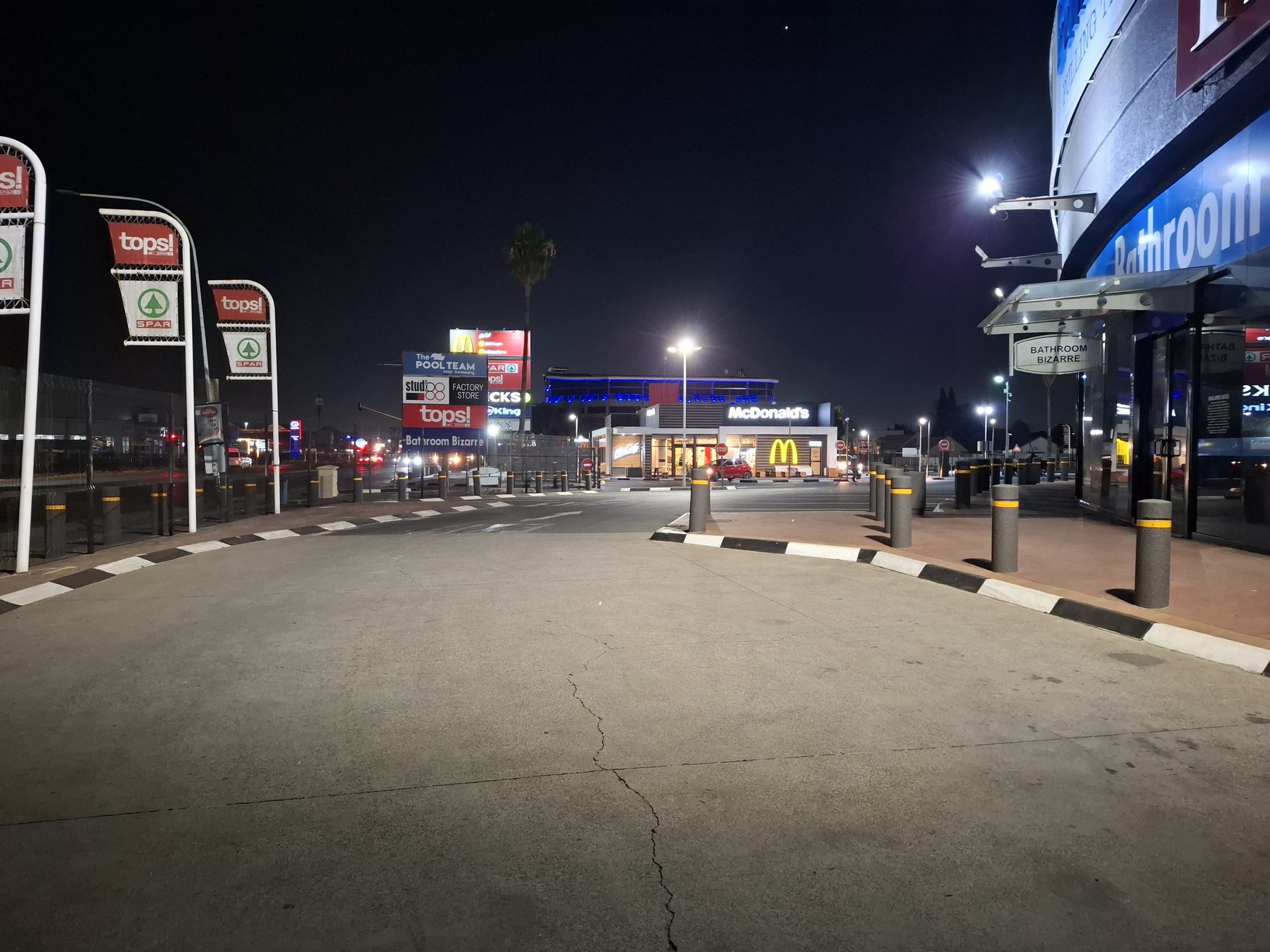 Forecourt and approach road lit at night