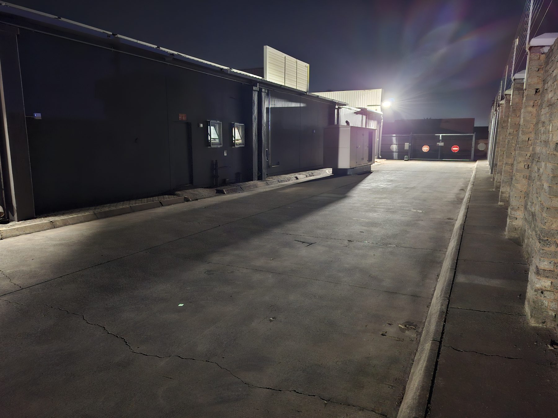Rear vehicle gate and access road lit by new lighting